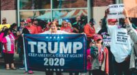 Woman holds Trump flag in support of Republican party and 2024 election