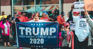 Woman holds Trump flag in support of Republican party and 2024 election